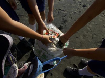 Ramassage de déchets plastiques sur la plage de Air Kunin avec des écoliers